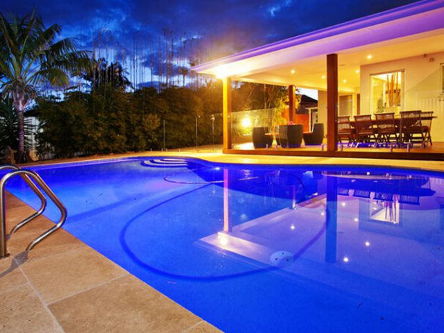 luxury backyard with pool lights