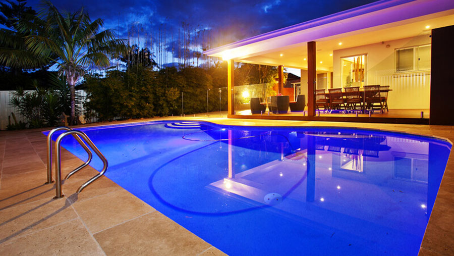 luxury backyard with pool lights