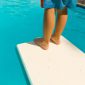 Child standing on edge of diving board